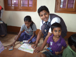 President Interact Club of St.Xavier H. S. School Duliajan Joydeep Phukan teaching a child to draw at Nirmala Orphanage Tinsukia